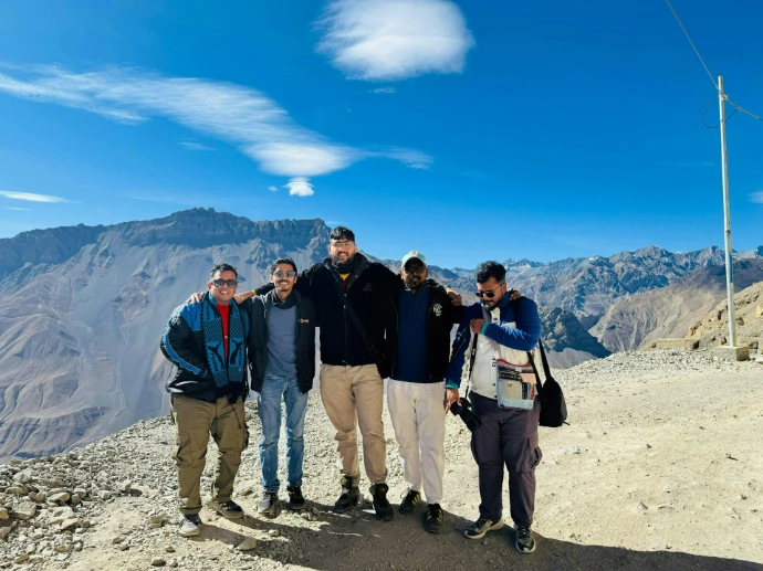 A group of men standing on top of a mountain